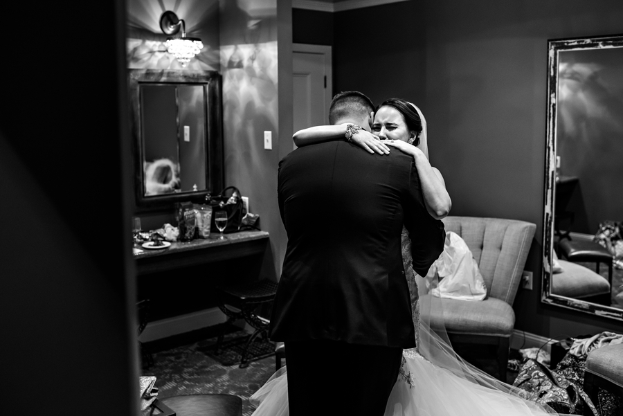 A groom holds his new wife as she cries.